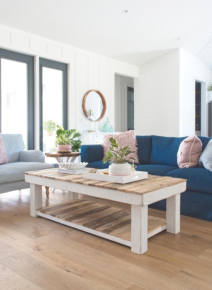 modern farmhouse living room navy blue sofa couch rectangle coffee table armchair ikea board and batten round mirror