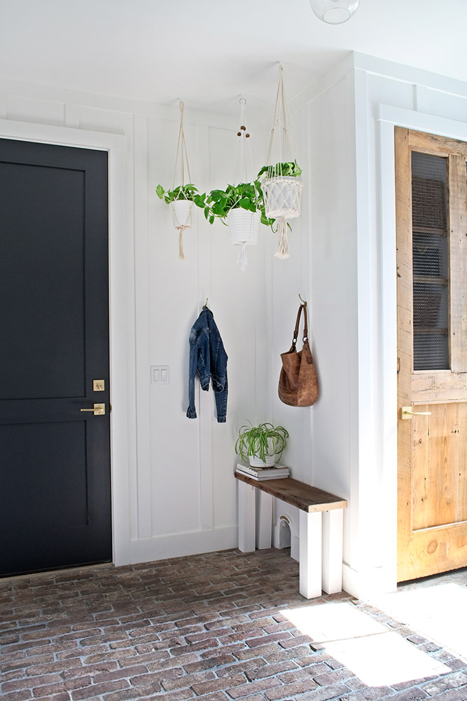 plant on bench with books reclaimed wood door