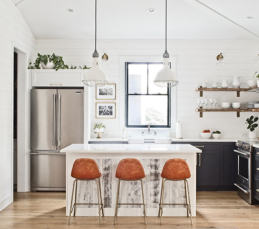 modern farmhouse kitchen with Stikwood on island, and dark navy blue cabinets and exposed wood shelving with shiplap backsplash
