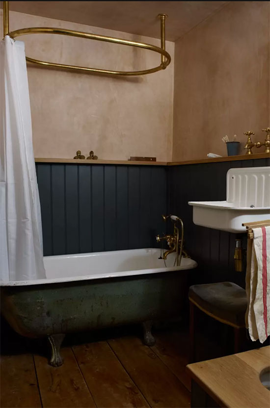 lime wash walls in small bathroom with vintage tub and bucket sink