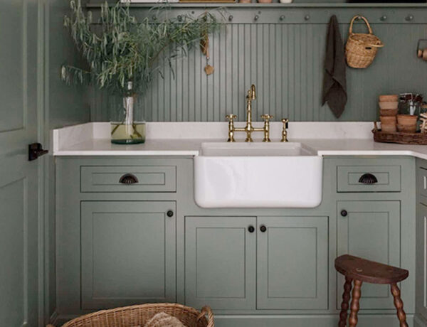 dark grey green cottage laundry room with farmhouse sink marble countertop and beadboard backsplash