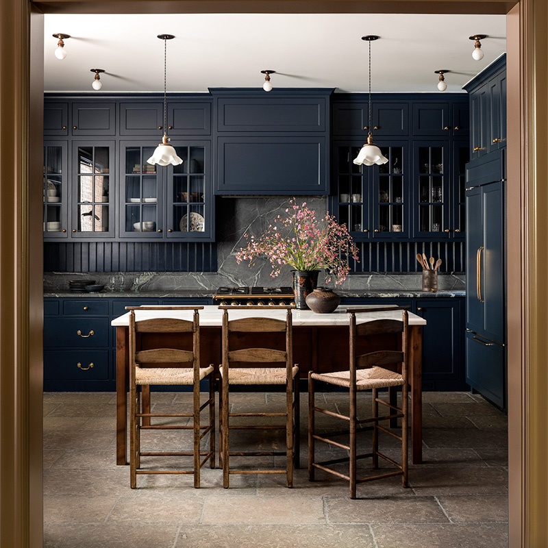 dark gray blue kitchen with English fluted pendant lamps over a table island
