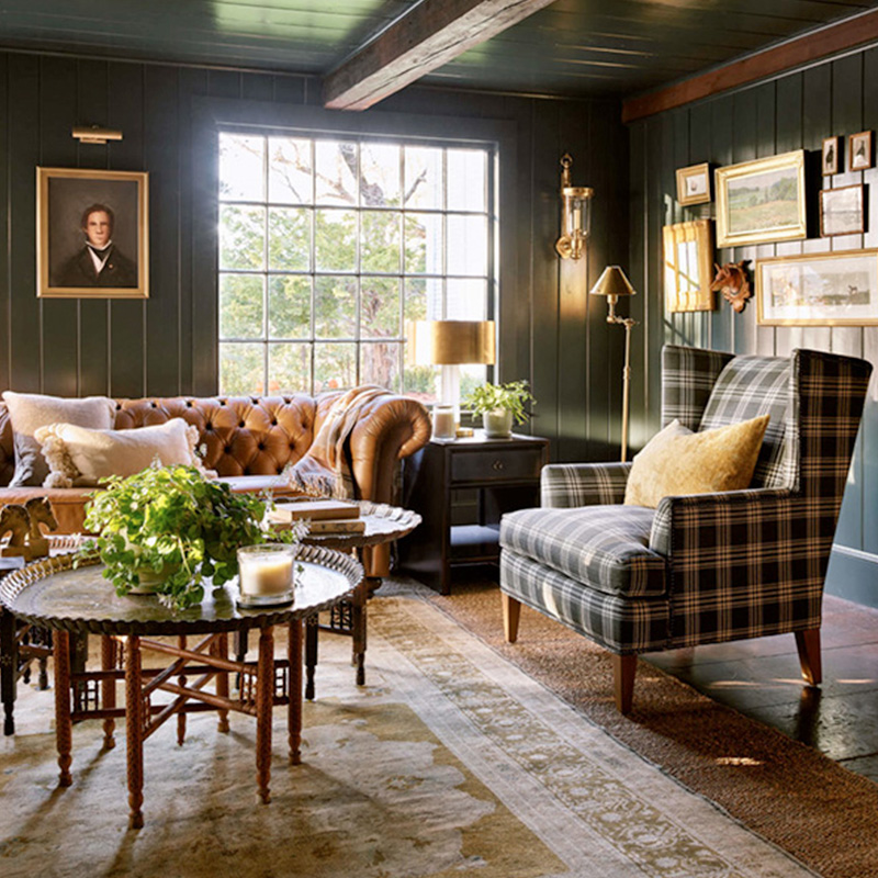 moody forest green gentlemen's study office with plaid armchair and leather Chesterfield sofa